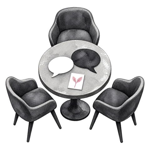 A small round table with four chairs, two speech bubbles resting on its surface.