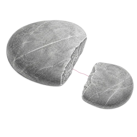Two stones that were once one, lying apart with a fine pink thread still spanning the gap between them.